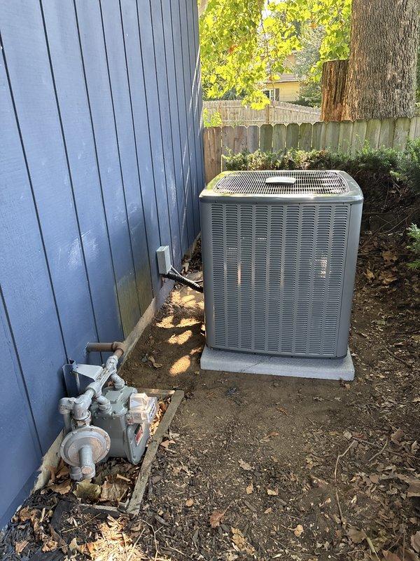 Completed full HVAC system installation including furnace and air conditioning condenser unit. Installed new furnace in mechanical room with proper labeling and identification tags applied to equipment housing. Mounted outdoor condensing unit on concrete pad in residential backyard with appropriate clearances from structure. Ran and connected refrigerant line sets between indoor and outdoor components using gray PVC piping with proper fittings and connections. Secured all electrical connections and verified proper voltage supply to both units. Tested system startup sequence and confirmed proper operation of both heating and cooling cycles. All equipment installed per manufacturer specifications and local code requirements.
