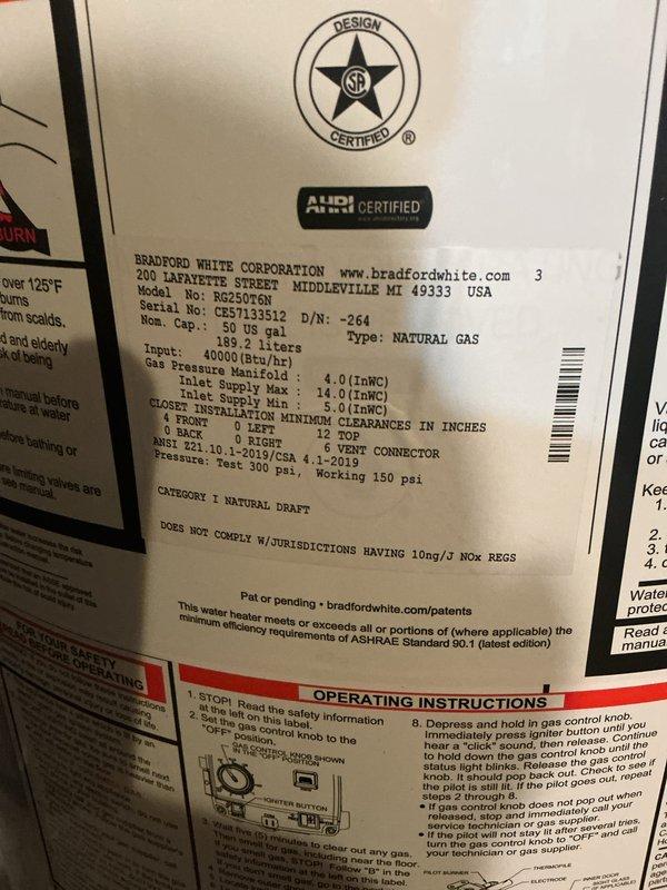Completed installation of a 50-gallon natural gas Bradford White water heater (Model BN250T6N) with a 40,000 BTU/H input capacity. The unit was properly positioned in the utility area with all necessary connections completed, including copper water supply lines, black iron gas piping with shut-off valve, and metal exhaust venting from the top of the unit.
