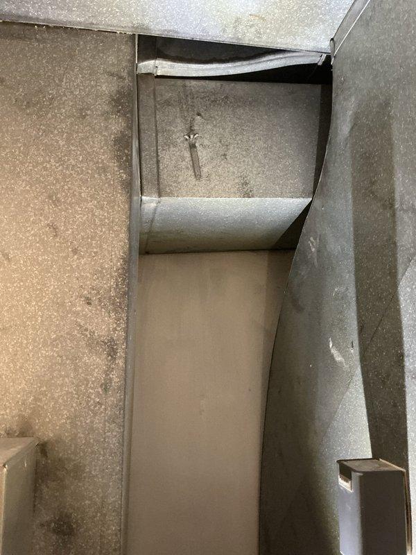 Completed geothermal estimate for replacement of indoor air handler unit on existing open loop geothermal heating and cooling system. Inspected 25-year-old furnace/air handler located in basement utility space with adjacent ductwork and control panel. Photographed existing equipment configuration including metal HVAC unit, cylindrical plenum ductwork, and interior duct components to document current installation for replacement specifications. Provided estimate for new indoor geothermal unit installation to replace aging equipment while maintaining existing ground loop system.