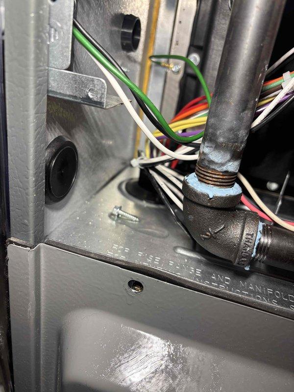 Responded to water leak alert on newly installed HVAC system where wet switch had shut down unit after detecting moisture. Upon inspection, found significant water accumulation in drain pan with standing water pooled across interior base of furnace cabinet. Investigated condensate drainage system including drain line connections, trap assembly, and primary drain routing. Cleared obstruction from condensate drain line and verified proper pitch and flow. Tested wet switch functionality and confirmed proper operation. Cycled system through complete cooling mode to verify condensate removal and drainage. Confirmed no further water accumulation and wet switch remained in normal operating position with system running properly.