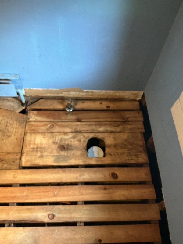 Conducted on-site assessment for bathroom remodeling project requiring multiple plumbing estimate options. Documented existing conditions including exposed floor joists, recessed alcove with visible PVC drain assembly and P-trap configuration, and wall-mounted shut-off valve. Photographed current plumbing infrastructure and construction state to prepare comprehensive estimate proposals for complete bathroom renovation scope.