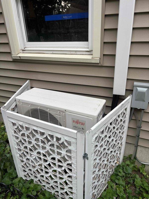 Completed annual cooling maintenance on a 17-year-old Fujitsu Halcyon mini-split system. Inspected outdoor condenser unit, which was properly housed in decorative lattice enclosure with adequate clearance and protection. Evaluated indoor blower wheel assembly and noted significant dust and debris accumulation on centrifugal fan blades and housing, with visible wear and surface deterioration consistent with system age. Documented equipment condition through photographs for service records. System operational at time of inspection.