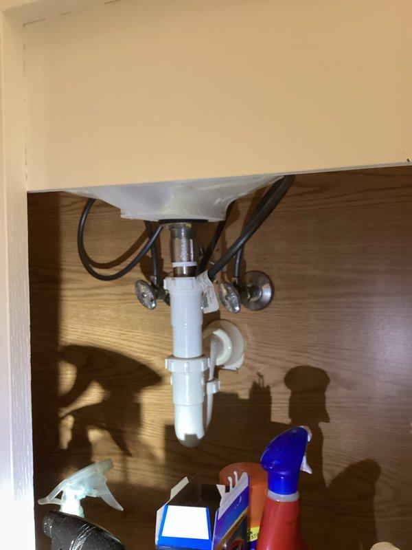 Installed new two-handle brushed nickel bathroom faucet with arched spout on existing vanity with undermount oval basin. Connected supply lines to existing shut-off valves beneath sink and tested for proper water flow and drainage. All connections verified leak-free and system operating correctly.