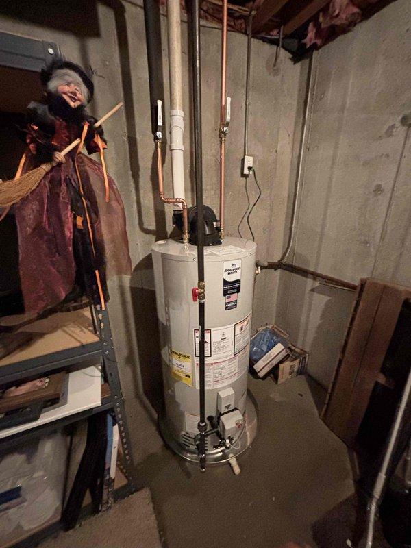 Completed installation of Bradford White 50-gallon automatic storage water heater, model RG1PV50S6N19, with 40,000 BTU/hr input rating in basement mechanical room. Connected all required copper supply and discharge piping, installed proper venting, and established electrical connections per manufacturer specifications and local code requirements. Unit tested and verified operational with all safety features functioning correctly.