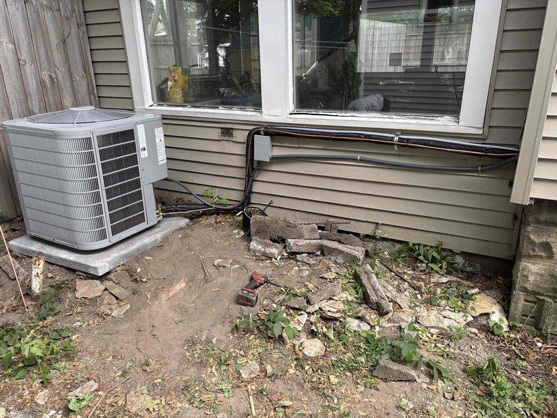Completed full air conditioning system replacement at residential property. Installed new outdoor condensing unit on concrete pad with proper refrigerant line connections and electrical conduit routing to interior furnace system. Connected new AC coil to existing furnace unit in basement mechanical room, installed condensate pump for proper drainage, and verified all ductwork connections to air handler plenum. System startup performed with successful operational testing of all components.