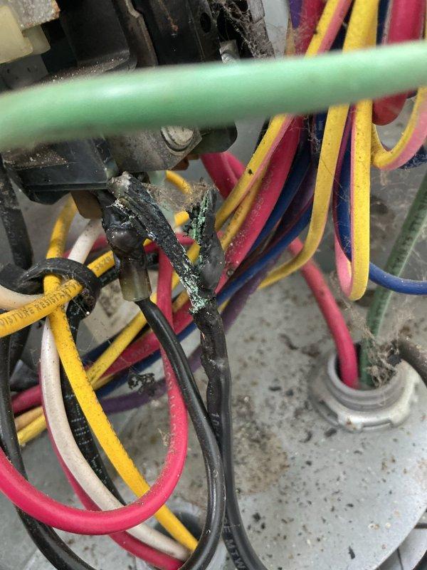 Responded to air conditioning system not cooling to temperature setpoint. Upon arrival, performed diagnostic inspection of the cooling system and associated electrical components. Inspected wiring connections and found evidence of deteriorated wire insulation with accumulated residue and corrosion on multiple electrical conductors in the equipment area. Documented existing conditions of electrical wiring bundle showing signs of environmental exposure and material degradation. Checked floor-mounted equipment connections and drainage components. System evaluated and photographic documentation completed for warranty records per three-year equipment coverage expiring 4-2033.