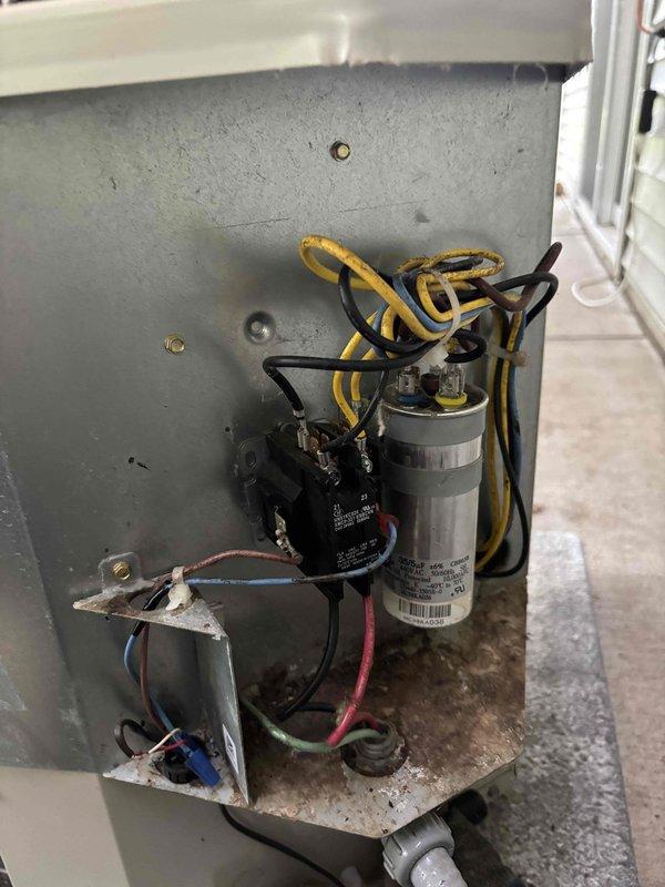 # AC Annual Cooling Maintenance - Payne System (2017)

Performed comprehensive annual cooling maintenance on a 5-year-old Payne air conditioning system. Upon inspection, discovered significant contamination within the electrical compartment, including accumulated debris, dirt, and organic nesting material throughout the base and surrounding components.

## Work Performed:

**Electrical Compartment Inspection & Cleaning:**
- Accessed electrical compartment and documented extensive debris buildup around capacitor, contactor, and wiring connections
- Identified contamination consistent with rodent activity affecting multiple electrical components
- Cleaned debris from compartment base, component mounting surfaces, and surrounding metal housing
- Verified integrity of all wire connections including yellow, blue, white, black, brown, red, and green conductors
- Inspected wire nut connections for security and proper termination

**Component Testing & Evaluation:**
- Tested dual run capacitor