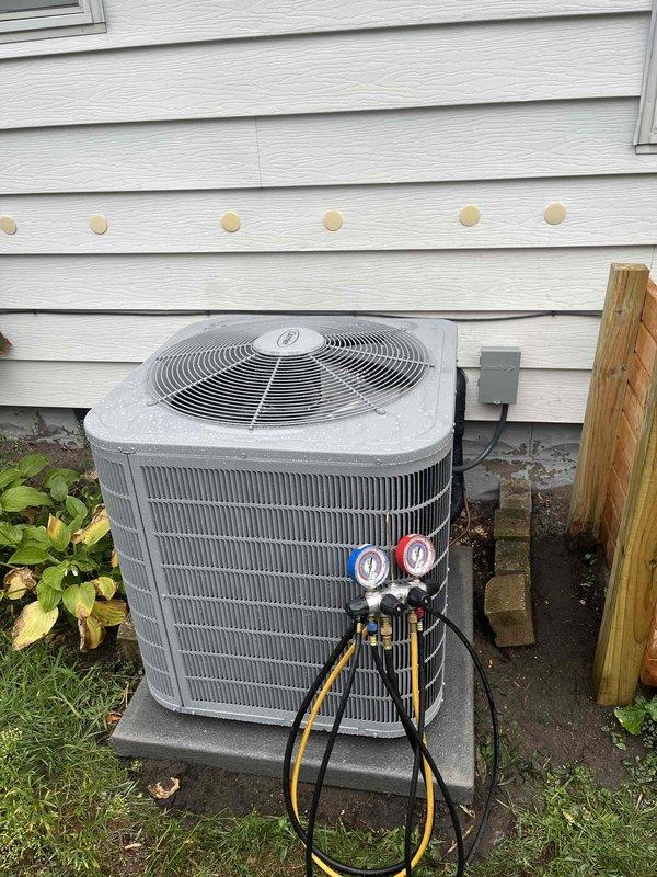 Completed full HVAC system installation including new furnace and air conditioning unit. Indoor air handler was installed in mechanical room with proper ductwork connections, electrical conduit routing, and refrigerant line installation. Outdoor condensing unit was positioned on concrete pad against exterior wall with electrical disconnect box mounted nearby. System was charged with refrigerant, tested using manifold gauge set to verify proper pressures, and commissioned to ensure all components functioning correctly. All equipment secured, connected to existing infrastructure, and left in operational condition.
