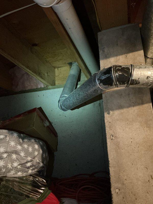 Responded to water leak emergency involving an 86-gallon EnergiAir water heater that had rusted through and was actively leaking. Upon arrival, found significant water damage on concrete floor and surrounding walls in basement utility area. Documented failed water heater unit with rust-through damage at base, along with existing plumbing connections and overhead ductwork configuration for replacement planning.