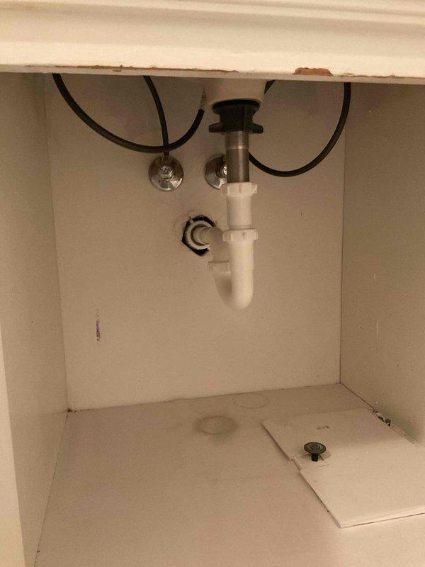 Completed faucet replacement using company-supplied fixture. Disconnected existing water supply lines, removed old faucet assembly, and installed new faucet with proper mounting and sealing. Reconnected hot and cold water supply lines with flexible hoses to shut-off valves, verified all connections for leaks, and tested faucet operation to ensure proper water flow and drainage through existing P-trap assembly.
