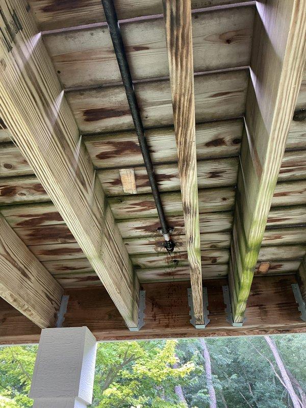 Responded to service call for intermittent gas leak on exterior gas grill supply line. Upon inspection, located leak point at connection beneath elevated deck structure. Performed leak detection testing, documented findings with photos showing installation routing through deck framing, and provided customer with repair options and safety recommendations.