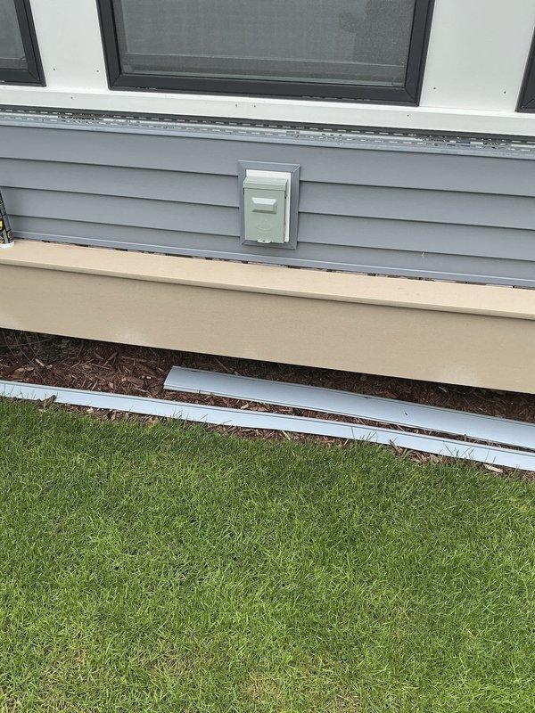 Conducted estimate for mini split installation in four seasons room with white shiplap walls and vaulted ceiling featuring exposed wooden beams. Assessed interior space layout, electrical access points on exterior gray siding, and determined optimal equipment placement for climate control system. Documented existing conditions and provided recommendations for ductless heating and cooling solution.