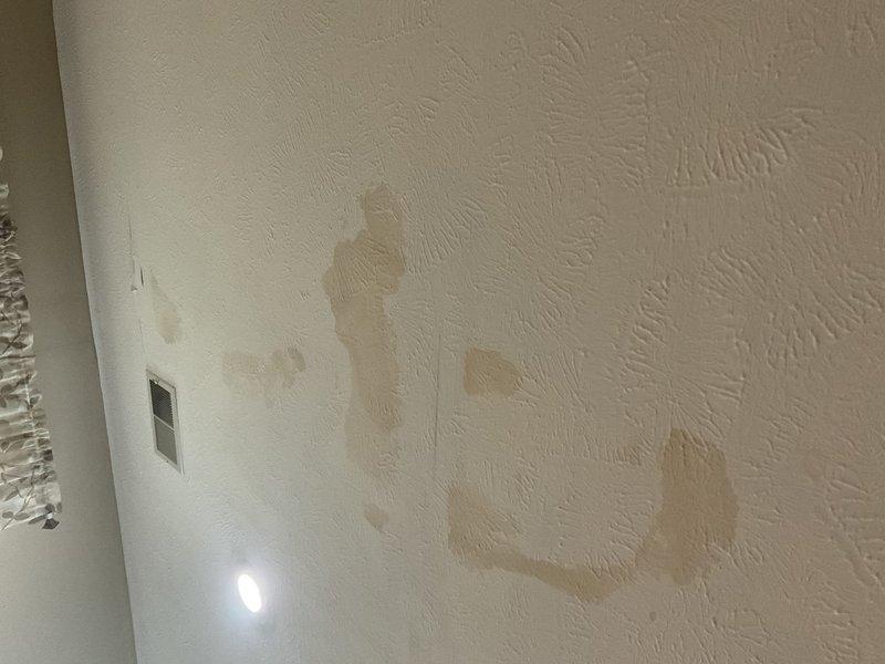 Responded to report of brown/tan water discoloration on basement ceiling below bathroom in 1996-built home, with issue progressively worsening over 4-year period since 2016. Conducted visual inspection of bathroom above affected area, examining toilet, flooring, and surrounding fixtures for signs of active leakage or moisture intrusion. Documented bathroom conditions and basement ceiling staining with photographs showing water damage patterns on textured ceiling and wall surfaces. No active leak observed during inspection; staining indicates historical water intrusion requiring further investigation to determine source, which may include toilet seal failure, supply line issues, or drain pipe concerns.