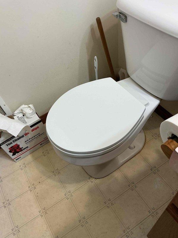 Responded to plumbing lead for potential toilet repair and relocation estimate. Upon arrival, conducted thorough inspection of bathroom facilities and documented existing conditions with photographs. Observed significant rust-colored staining and water damage on vinyl floor tiles surrounding toilet base and water supply line connection point, indicating previous or ongoing leak issues. Examined chrome flexible water supply line with shut-off valve for signs of failure or seepage. Assessed toilet installation, floor condition, and supply line integrity to determine repair requirements. Provided customer with professional assessment of toilet repair needs and prepared estimate for relocating waste tub as requested.
