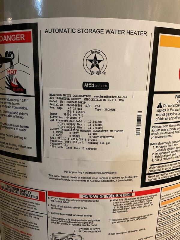 Completed installation of a 40-gallon Bradford White power vent LP gas water heater in basement utility area. Unit was properly connected to existing plumbing system with copper supply lines, PVC exhaust venting routed through ceiling, and all safety controls verified operational per manufacturer specifications.