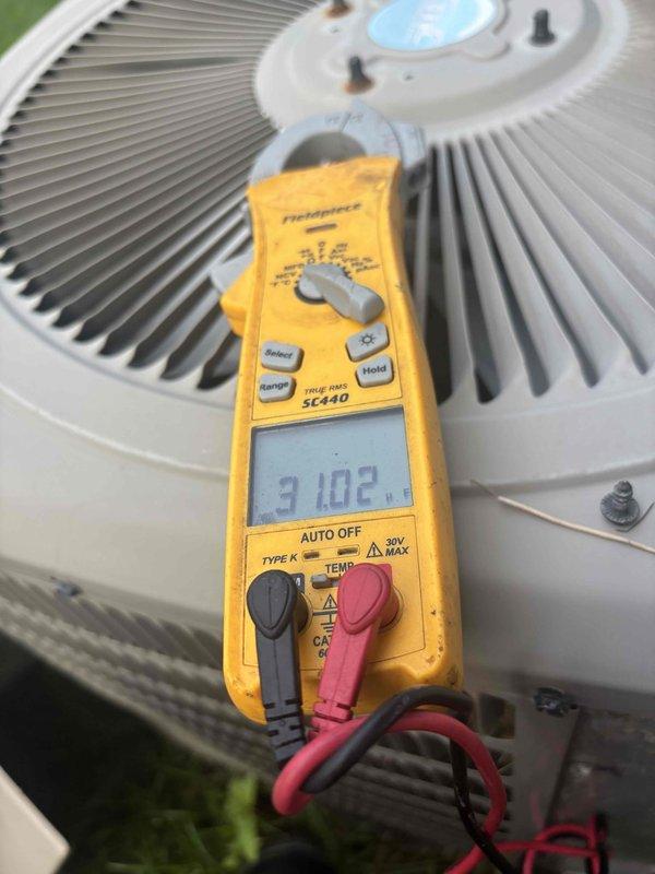 Completed annual cooling maintenance on 9-year-old residential air conditioning system. Performed comprehensive system inspection including electrical testing with digital multimeter, verifying proper voltage and amperage readings at the outdoor condensing unit. Inspected capacitor with date code from 2016, noting visible discoloration on component surface. All electrical connections checked and found secure with proper wire terminations. System operational and cooling effectively at time of departure.