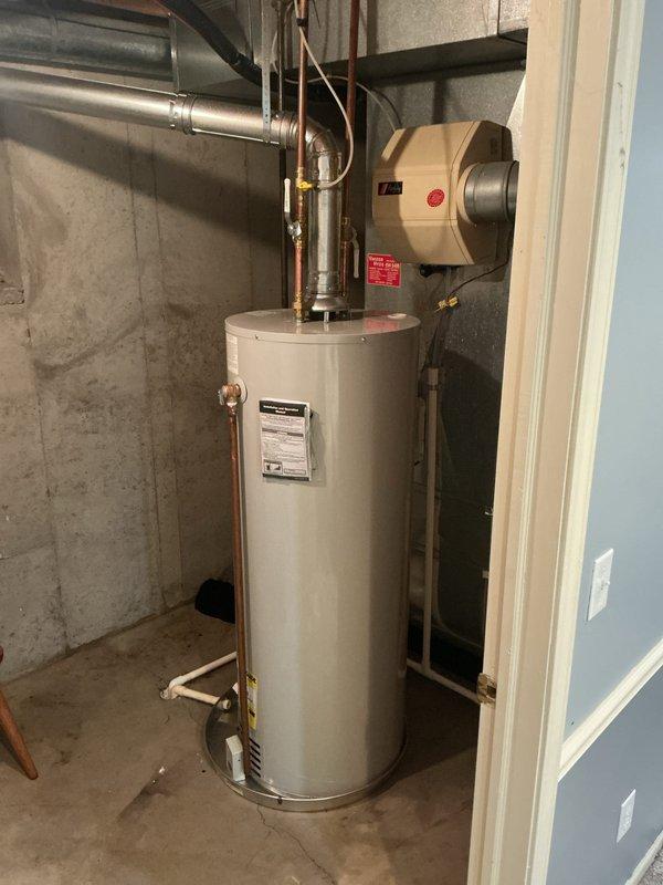 Completed installation of 50-gallon residential water heater with 6-year parts and 1-year labor warranty in basement utility room. Connected copper supply and discharge lines with proper valves and fittings, ensuring all plumbing connections meet code requirements and are properly secured within existing HVAC infrastructure.