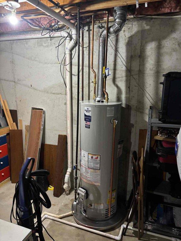 Responded to service call for suspected plumbing leak reported to have been ongoing for approximately one month, with toilet running continuously for extended periods. Conducted thorough inspection of basement mechanical room and plumbing fixtures. Examined water heater installation, supply lines, and drainage systems in basement utility area. Inspected all visible copper and PVC piping for signs of moisture, corrosion, or active leaks. Assessed kitchen sink plumbing system including faucet assembly, supply connections, and drain lines. Verified proper operation of all fixtures and checked for hidden leaks behind walls and under countertops. Documented conditions with photographic evidence showing water heater, basement plumbing infrastructure, and kitchen sink area for service records.