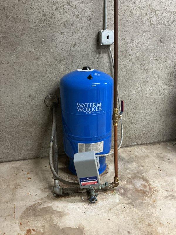 Responded to service call for well pump cycling issue where pressure system was turning on and off excessively. Inspected Water Worker pressure tank and associated plumbing components in basement utility area. Evaluated pressure switch, tank air charge, and system operation following recent emergency repairs performed by another contractor. Documented existing conditions including pressure tank, copper supply lines, brass fittings, and pressure control components. Assessed exterior utility connections and gas meter area. Provided quote for installation of new outdoor hose bibs as requested.
