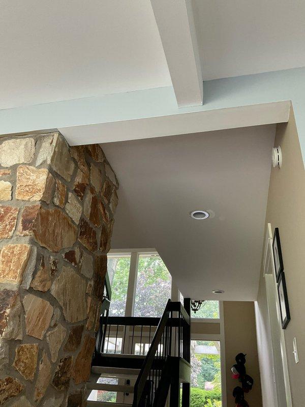 Completed electrical estimate for installation of new outlet above stone fireplace to accommodate wall-mounted television. Assessed existing electrical infrastructure, ceiling access points through coffered beam system, and optimal routing pathway to minimize visible conduit while maintaining code compliance. Documented stone fireplace configuration, mantel placement, and ceiling height measurements to determine proper outlet positioning and installation methodology for concealed wiring run.