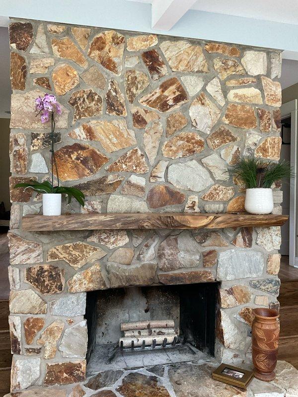 Completed electrical estimate for installation of new outlet above stone fireplace to accommodate wall-mounted television. Assessed existing electrical infrastructure, ceiling access points through coffered beam system, and optimal routing pathway to minimize visible conduit while maintaining code compliance. Documented stone fireplace configuration, mantel placement, and ceiling height measurements to determine proper outlet positioning and installation methodology for concealed wiring run.