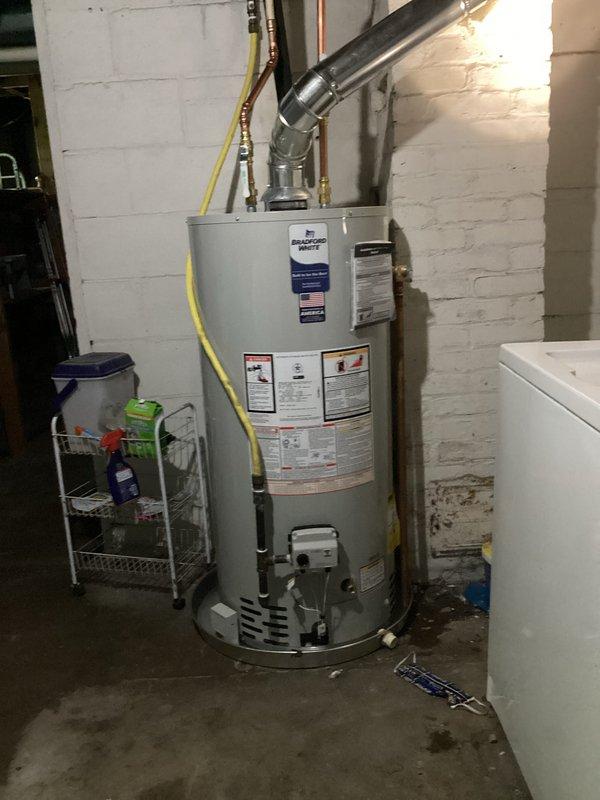 Successfully installed a 40-gallon Bradford White natural gas water heater (Model RG240S6N) in basement utility area, including new chimney liner installation and water line connections. Completed all venting requirements with proper metallic flue pipe configuration, connected yellow flexible gas supply line to unit's gas control system, and ensured all connections met manufacturer specifications for 40,000 BTU/hr input rating and proper gas pressure settings.