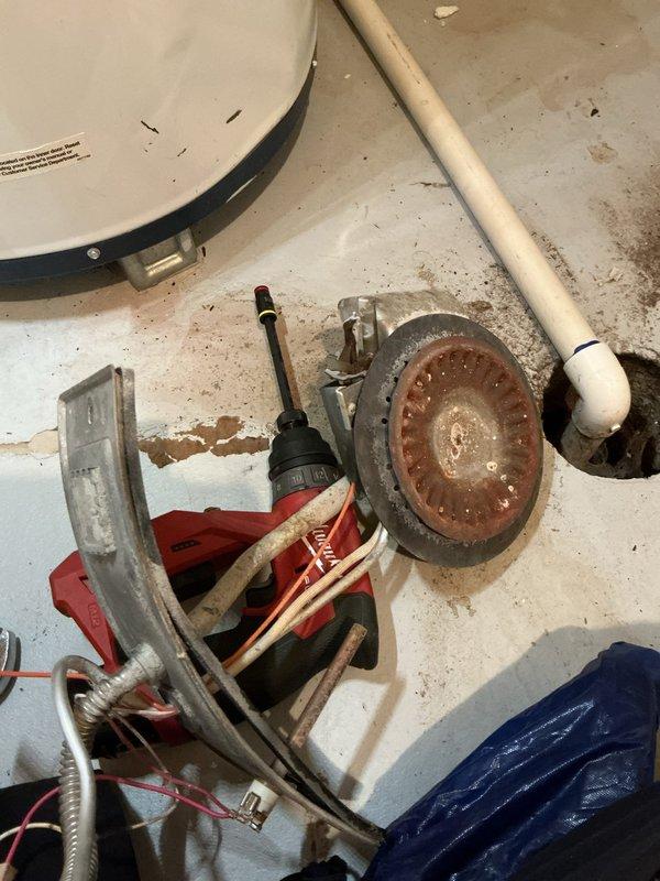 Responded to a no-heat complaint on a 10-year-old water heater. Upon inspection, found severely corroded heating element with heavy mineral buildup and rust accumulation preventing proper operation. Removed failed element, cleaned sediment from tank opening, and installed replacement heating element. Tested unit operation and verified proper heating function restored. Discussed membership benefits with customer during service call.