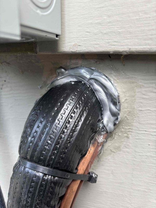 Sealed exterior wall penetration where flexible HVAC duct enters building to prevent rodent intrusion. The opening around the ductwork connection point showed significant deterioration with gaps and irregular edges that provided potential entry points for mice. Applied appropriate sealant material around the perimeter of the duct penetration to eliminate air gaps and secure the connection point against pest entry while maintaining proper duct functionality.