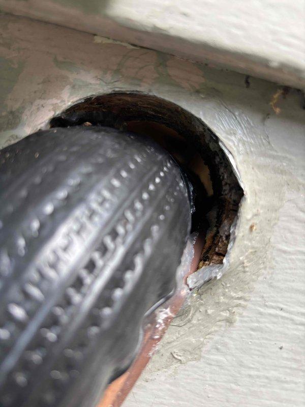 Sealed exterior wall penetration where flexible HVAC duct enters building to prevent rodent intrusion. The opening around the ductwork connection point showed significant deterioration with gaps and irregular edges that provided potential entry points for mice. Applied appropriate sealant material around the perimeter of the duct penetration to eliminate air gaps and secure the connection point against pest entry while maintaining proper duct functionality.