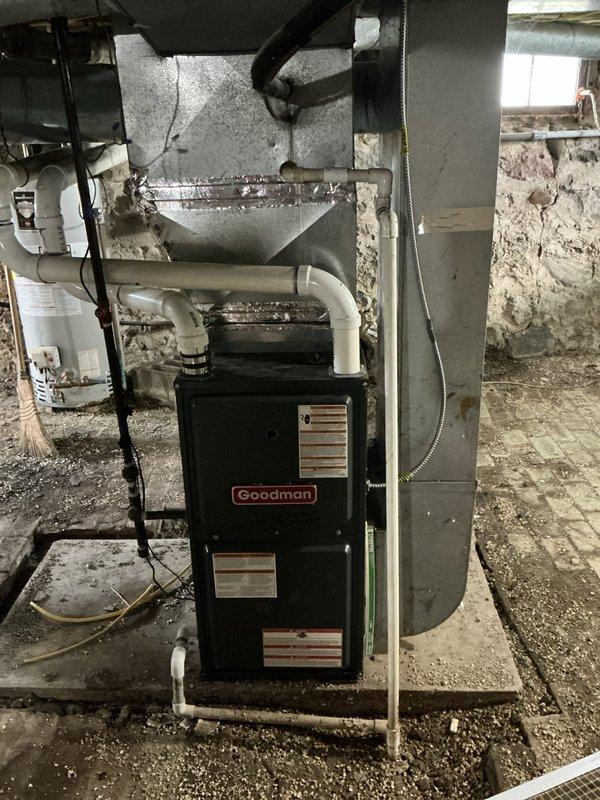 Conducted on-site assessment for furnace and water heater replacement estimate at residential property undergoing ownership transition. Documented existing Goodman furnace installation in basement mechanical room, including current PVC venting configuration, electrical connections, ductwork layout, and thermostat system. Gathered necessary measurements and specifications to prepare comprehensive replacement estimate for new heating equipment and water heater installation.