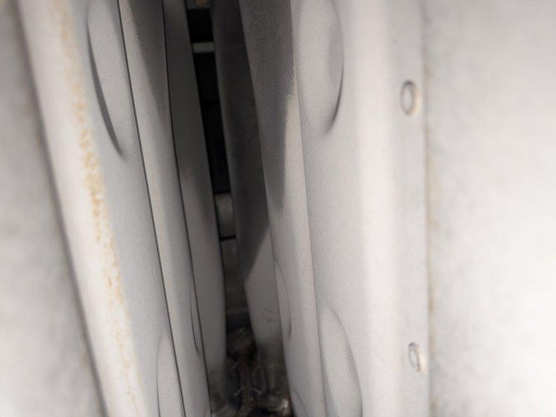 Responded to service call for air conditioning system running continuously without reaching set temperature. Upon inspection, discovered significant dirt accumulation and debris on evaporator coil and surrounding components, restricting proper airflow and heat transfer. Performed complete system tune-up including thorough cleaning of evaporator coil, inspection of refrigerant levels, verification of thermostat operation, and assessment of blower motor function. Documented equipment condition with photos showing heavy soiling on unit components prior to cleaning. System tested after service and confirmed proper cycling and temperature achievement. Unit now operating within normal parameters.