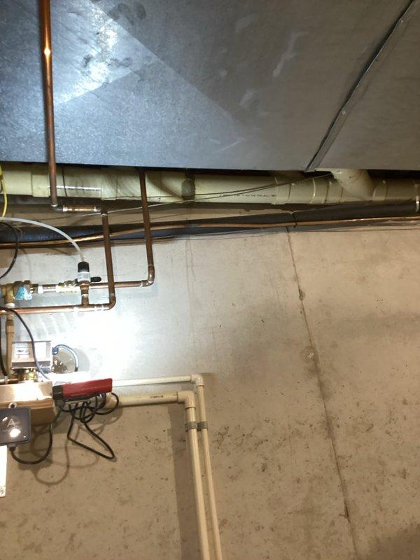 Conducted comprehensive inspection of residential HVAC system in basement utility area per homeowner request for repair and replacement options. Evaluated furnace unit, ductwork system including metal supply ducts with reflective insulation and flexible branch connections, condensate drainage lines, and overall system integration with existing plumbing infrastructure. Documented equipment conditions, mechanical components, and installation quality through photographic evidence for client review and recommendation development.