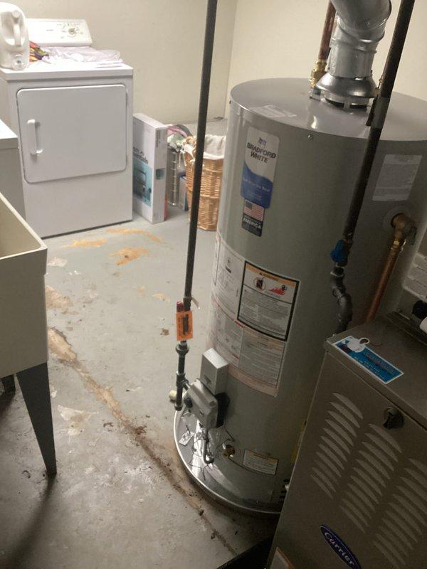 Completed installation of 40-gallon natural gas water heater with 6-year tank and 6-year parts warranty in residential utility room. Unit was installed in short configuration with proper venting through existing exhaust system, copper supply line connections, and gas line hookup with shutoff valve. All plumbing connections were secured with appropriate fittings, system was tested for proper operation and safety compliance, and installation met manufacturer specifications and local code requirements.