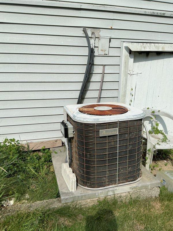 Responded to no cooling call on 20-year-old Amana air conditioning system. Upon arrival, verified furnace fan operational but no cooling output from outdoor condenser unit. Inspected electrical panel and confirmed tripped circuit breaker supplying power to outdoor unit. Reset breaker and restored power to condenser. System tested and verified proper operation with adequate cooling restored. Advised customer of unit age and recommended monitoring system performance given equipment is near end of typical service life.