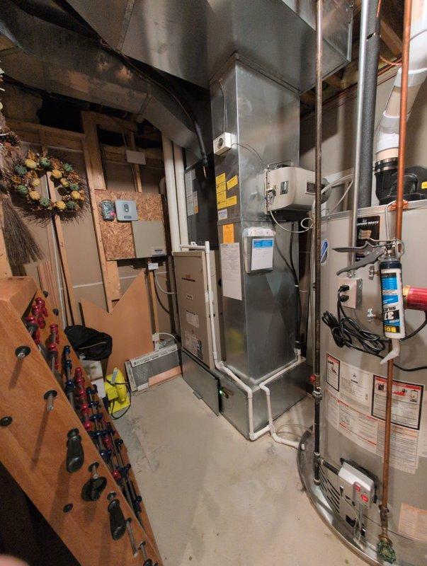 Completed full residential air conditioning system replacement including outdoor Amana condenser unit and indoor air handler. Installed new condenser on existing concrete pad with proper refrigerant line connections, electrical disconnect, and condensate drainage. Mounted indoor air handler in basement mechanical room with new ductwork integration. System commissioned, tested for proper operation, and verified all electrical connections meet code requirements.