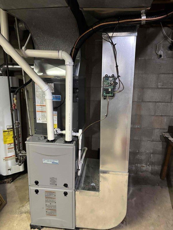 Completed full air conditioning system replacement at residential property. Removed existing outdoor condensing unit and installed new Enforcer brand AC unit on concrete pad against brick exterior wall, with proper electrical conduit and refrigerant line connections routed through wall penetration. Indoor furnace and coil system verified for compatibility with new outdoor unit. System fully charged with refrigerant, electrical connections tested and secured, all safety controls verified operational. Unit positioned on level concrete pad with adequate clearance for airflow and future service access. Final system startup completed with temperature differential and operational parameters confirmed within manufacturer specifications.