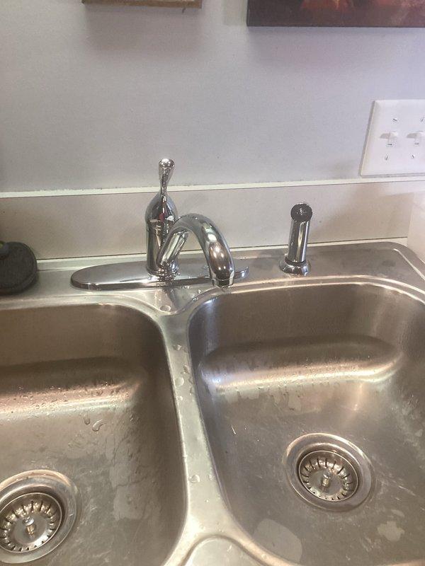 Responded to service call for malfunctioning kitchen sink hose. Upon inspection, assessed the pull-out spray hose assembly and associated connections beneath the double-basin stainless steel sink. Verified proper operation of chrome shut-off valves, supply lines, and spray attachment. Addressed hose functionality issues and ensured secure connections at faucet assembly and under-sink mounting points. Tested system for proper water flow and confirmed leak-free operation of all components upon completion.
