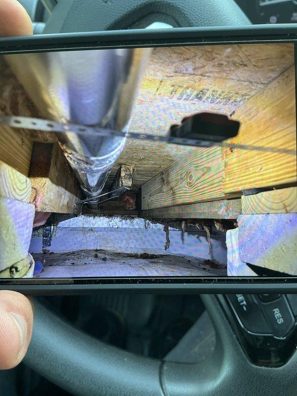 Conducted inspection of crawl space addition beneath dining room area to assess ventilation and condensation issues affecting dryer vent system. Documented existing conditions including inadequate air circulation causing moisture accumulation on ductwork, leading to recurring clogs. Photographed crawl space infrastructure showing fiberglass insulation, floor joists, and current ductwork configuration. Evaluated space constraints and airflow patterns to determine feasibility of installing zoned HVAC system for independent temperature control of the addition. Provided recommendations for improving ventilation and resolving condensation problems while discussing zoning options to enhance climate control in the affected area.