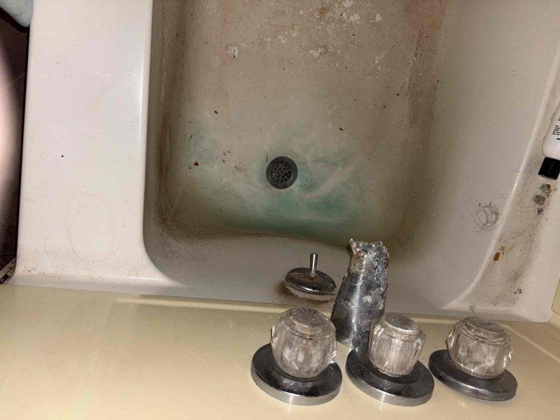 Responded to emergency call for flooded basement in 1960s-era home. Upon arrival, assessed standing water conditions in basement utility area and inspected water heater and associated copper plumbing lines for source of leak. Identified compromised plumbing connections near water heater with visible corrosion on brass fittings and joints. Shut off main water supply and drained affected lines. Replaced faulty brass connectors and tightened copper pipe joints at water heater connections. Tested system for leaks and restored water service. Additionally addressed secondary issue of multiple clogged drains throughout home. Cleared severely clogged sink drain using mechanical auger and cleared additional sink drains with cable snake equipment. Removed shower fixtures for access to drain assembly, cleared accumulated debris and mineral buildup causing slow drainage in shower basin. Reassembled fixtures and tested all drains for proper flow. Recommended customer monitor basement area for any r