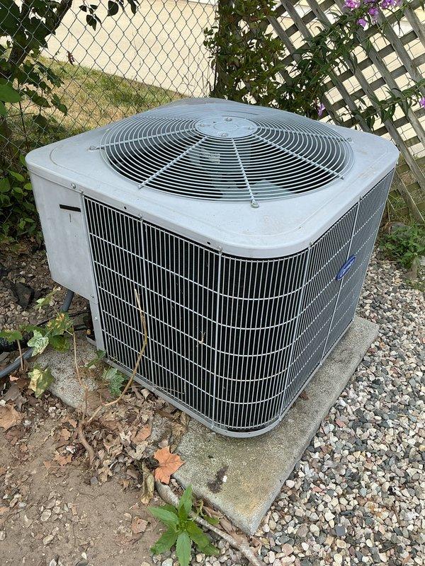 Completed quoted repair work on residential HVAC system requiring refrigerant service. Accessed exterior wall opening with OSB covering and installed electrical conduit routing from junction box to ground level. Serviced outdoor condensing unit, performing refrigerant work on the aging system positioned on concrete pad in backyard area. Work completed over 3-4 hour timeframe with additional technician return visit scheduled for refrigerant charging procedures.