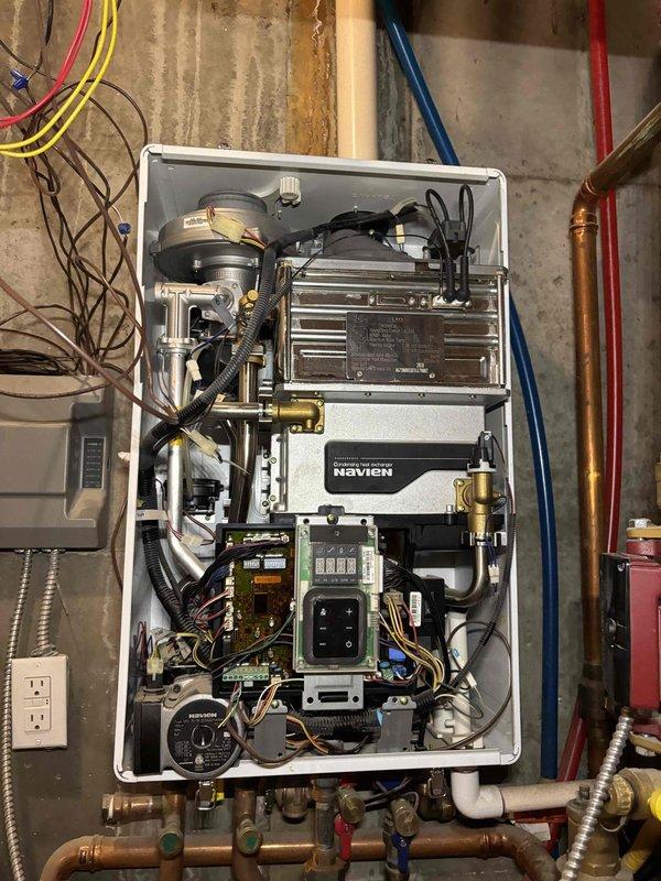 Performed boiler repair on a Navien wall-mounted unit during a 4-hour service call. Accessed internal components by removing the front cover to diagnose and address system issues. Inspected heat exchanger assembly, blower motor, circuit boards, wiring harnesses, pumps, sensors, and control modules. Serviced multiple zone valves with associated Honeywell control boxes and verified proper operation of copper piping connections and ball valves. Trip charge was waived per company authorization.