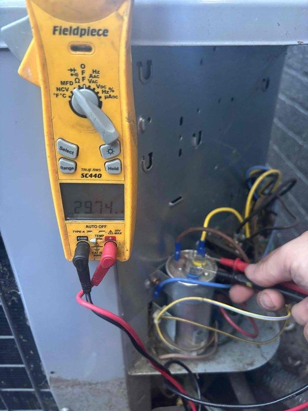 Completed annual cooling maintenance and tune-up on residential air conditioning system. Performed comprehensive electrical diagnostics using clamp meter, recording voltage reading of 506V and capacitor measurement of 29.14 MFD. Inspected all electrical connections, tested capacitor functionality, and verified proper system operation to ensure optimal cooling performance for the season.