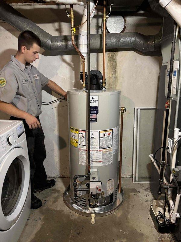 Successfully installed a 50-gallon power vent natural gas water heater in basement utility room. Completed all copper piping connections with brass shut-off valves, installed power vent motor assembly on top of unit, and verified proper venting configuration. Ensured all connections met code requirements, tested system operation, and confirmed no leaks at any connection points.