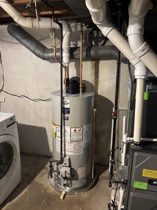 Successfully installed a 50-gallon power vent natural gas water heater in basement utility room. Completed all copper piping connections with brass shut-off valves, installed power vent motor assembly on top of unit, and verified proper venting configuration. Ensured all connections met code requirements, tested system operation, and confirmed no leaks at any connection points.