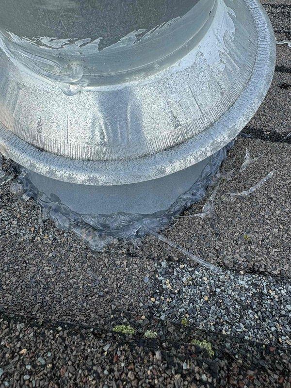 Responded to water heater alarm complaint with reported source above unit. Upon inspection, located water heater exhaust vent on rooftop with severe ice and frost accumulation on ductwork and flue pipe. Ice buildup on metal vent components was causing blockage and triggering alarm system. Documented conditions showing extensive frost coating on cylindrical duct collar, flange connections, and vertical flue stack penetrating roof surface. Identified restricted airflow due to frozen condensation accumulation as root cause of alarm activation. Recommended immediate ice removal from exhaust components and evaluation of venting system for proper draft and condensation management to prevent future freezing issues.