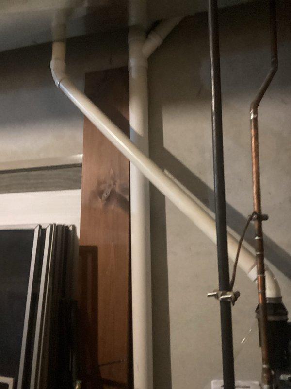 Responded to service call addressing multiple plumbing concerns throughout the residence. Inspected and documented main water supply lines and shutoff valve system in basement mechanical space, photographing copper supply lines, PVC drainage systems, and existing shutoff configuration for whole-home water control estimate. Evaluated hot water heater for inconsistent heating performance and documented unit specifications including age and manufacturer information. Replaced washing machine supply hoses with new reinforced stainless steel braided hoses to prevent potential failure. Diagnosed and repaired leaking kitchen faucet by replacing worn cartridge and O-rings. Adjusted toilet flush mechanism and replaced flapper valve to restore consistent full-flush operation.