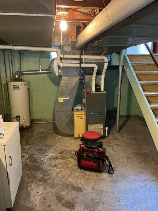 Responded to emergency no-hot-water call and conducted on-site assessment of failed water heater in basement utility area. Documented existing equipment and surrounding conditions, including water heater failure, basement mechanical room layout with furnace and HVAC systems, and evidence of moisture issues on concrete floor and wall surfaces near ductwork penetration. Prepared comprehensive estimate for complete water heater replacement to restore hot water service.