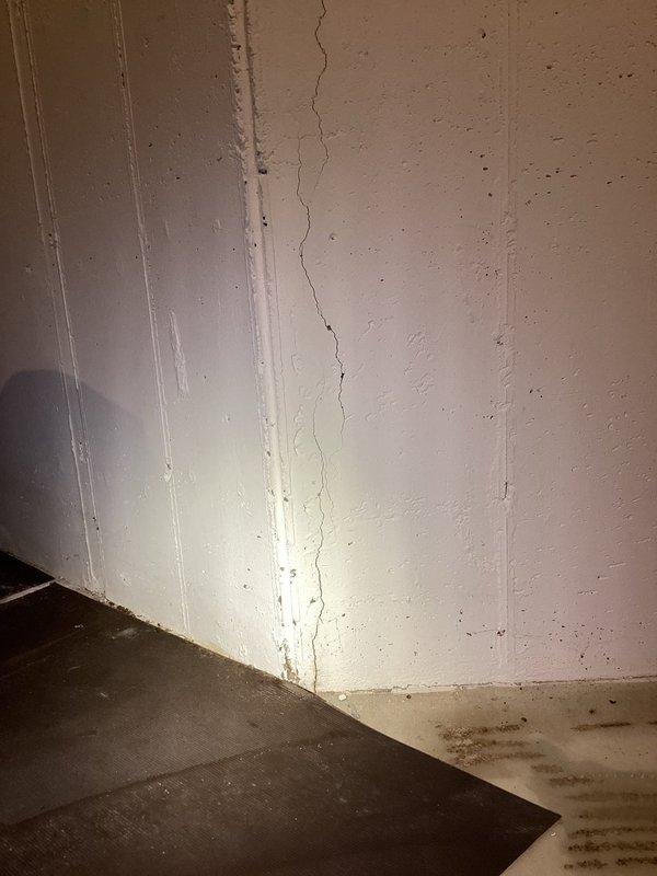 Responded to water leak investigation in basement. Upon arrival, inspected affected area and documented extensive moisture damage along interior corner walls with significant vertical cracking at wall seam and water staining near floor level. Photographed damaged areas showing deteriorated wall surfaces with discoloration and evidence of ongoing moisture intrusion at foundation level. Recommended follow-up assessment to determine source of water penetration and develop comprehensive repair plan for structural crack sealing and moisture remediation.
