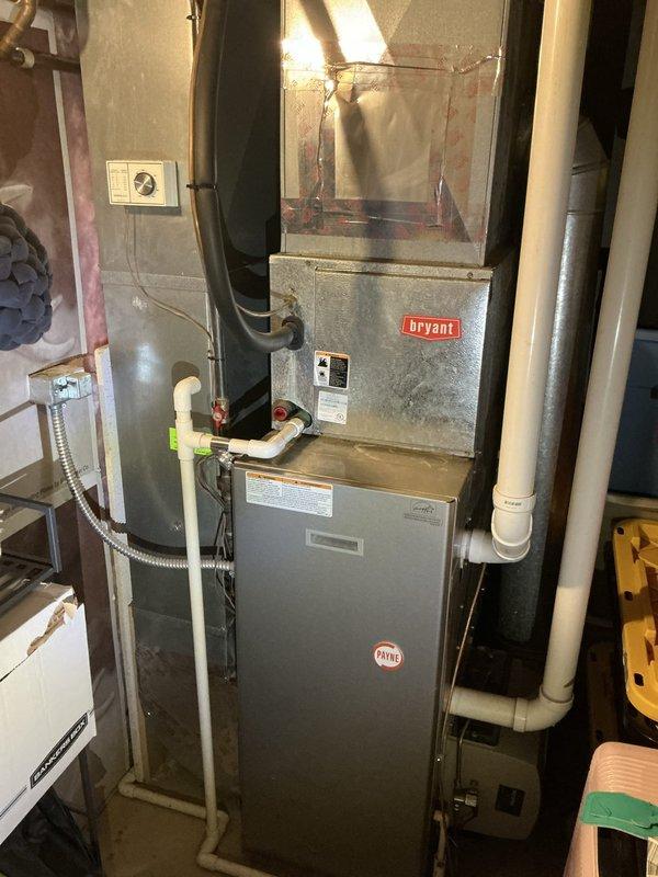 Responded to service call for residential HVAC system with no airflow and complete loss of cooling capacity. Upon arrival, inspected existing Bryant furnace and outdoor condenser unit, both approximately 20 years old and original to the home. Documented current system configuration including basement-installed gas furnace with associated ductwork, PVC venting, and exterior condensing unit positioned on rock bed against building exterior. Photographed both indoor and outdoor equipment to assess overall system condition and installation layout. Provided comprehensive estimate for complete HVAC system replacement including new furnace and air conditioning equipment to address whole-house comfort needs, as previous contractor had recommended full system replacement due to age and operational failure.