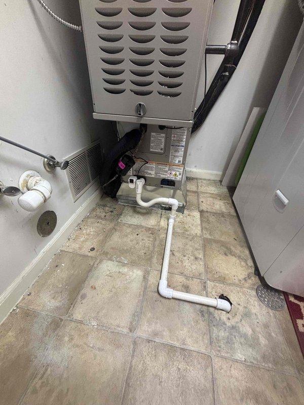 Completed full HVAC system installation including new Carrier furnace and air conditioning unit in residential utility space. Installed air handler with filter box assembly, connected rigid and flexible ductwork, and ran PVC condensate drain lines throughout mechanical room. Mounted electrical controls and verified all connections for proper system operation.